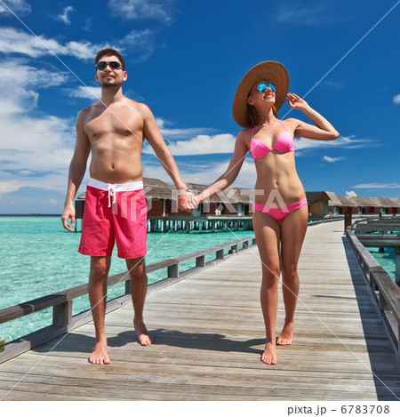 Couple on a beach jetty at Maldives 6783708