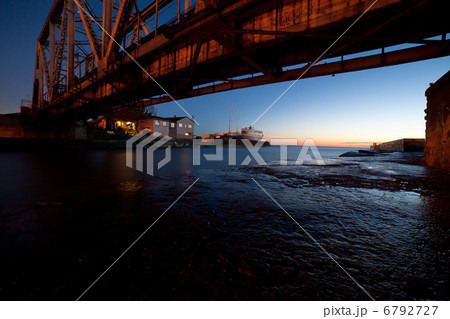 Railway bridge over strait with colorful sunset light 6792727