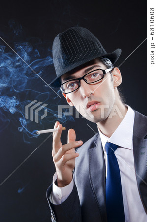 Young man smoking cigarette 6810608