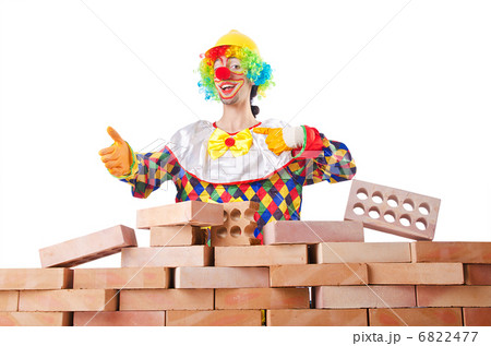 Bad construction concept with clown laying bricks Bad construction concept with clown laying bricks 6822477