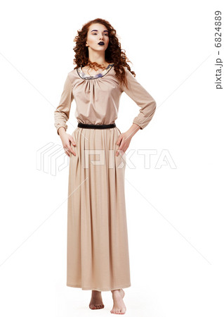 Romantic Elegant Barefoot Frizzy Woman in Brown Tunic posing 6824889