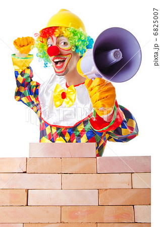 Bad construction concept with clown laying bricks 6825007