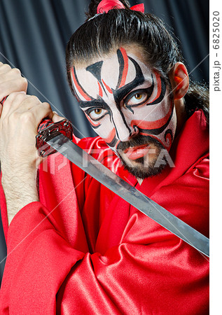Man with face mask and sword 6825020