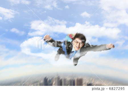 Young businessman flying with parachute on back Young businessman flying with parachute on back 6827295