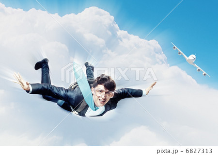 Young businessman flying with parachute on back 6827313
