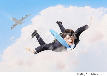 Young businessman flying with parachute on back Young businessman flying with parachute on back 6827328