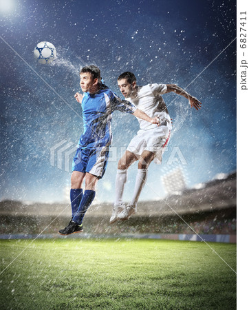 two football players striking the ball two football players striking the ball 6827411