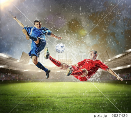 two football players striking the ball 6827426