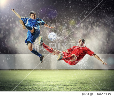 two football players striking the ball two football players striking the ball 6827439