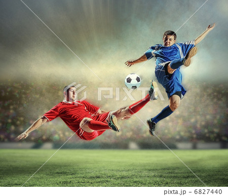 two football players striking the ball 6827440