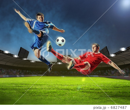 two football players striking the ball two football players striking the ball 6827487