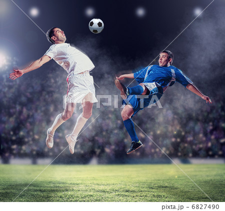 two football players striking the ball 6827490