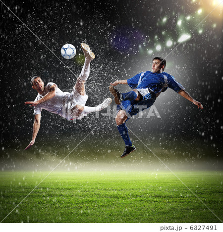 two football players striking the ball two football players striking the ball 6827491