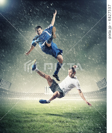 two football players striking the ball 6827537