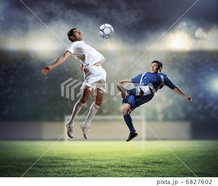 two football players striking the ball 6827602