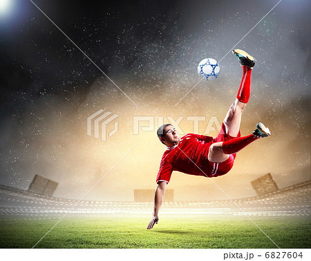 football player striking the ball football player striking the ball 6827604