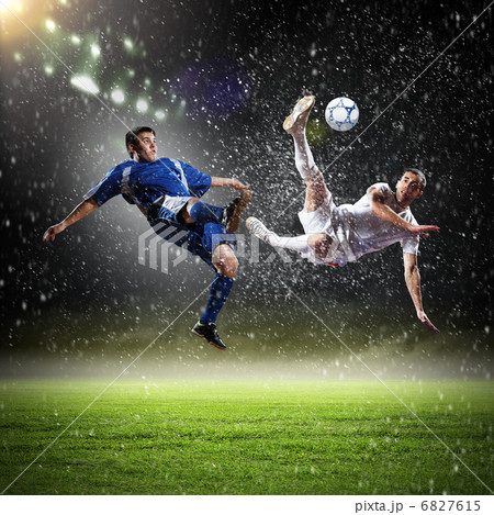 two football players striking the ball two football players striking the ball 6827615