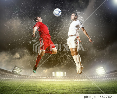 two football players striking the ball two football players striking the ball 6827621