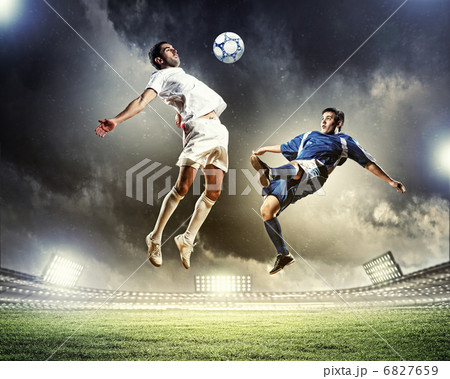 two football players striking the ball 6827659