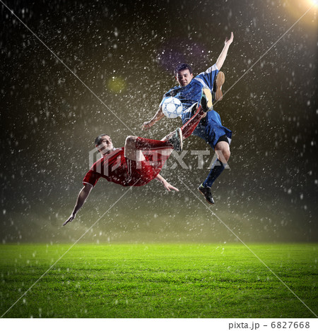 two football players striking the ball 6827668