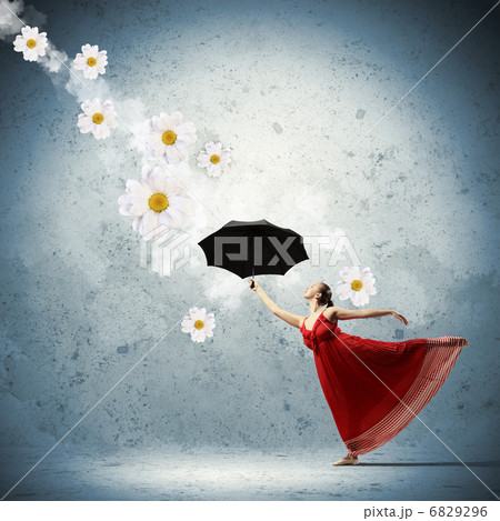 Ballet dancer in flying satin dress with umbrella 6829296