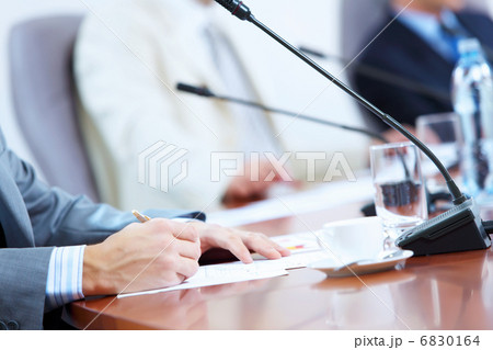 Hands of businessman writing with pen 6830164