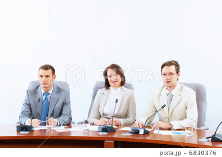 Three businesspeople at meeting 6830376