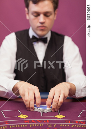 Dealer shuffling the deck Dealer shuffling the deck 6830868