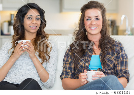 Two women holding cups of coffee Two women holding cups of coffee 6831135
