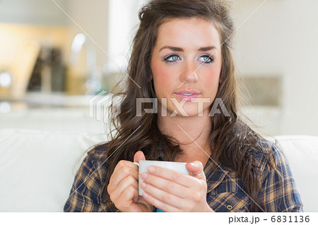 Girl holding a mug with two hands Girl holding a mug with two hands 6831136