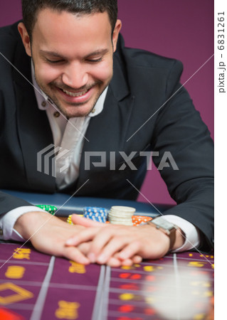Man happily grabbing chips 6831261