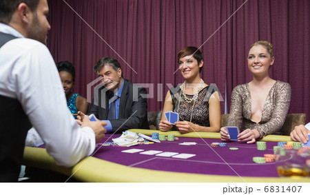 Women smiling at dealer Women smiling at dealer 6831407