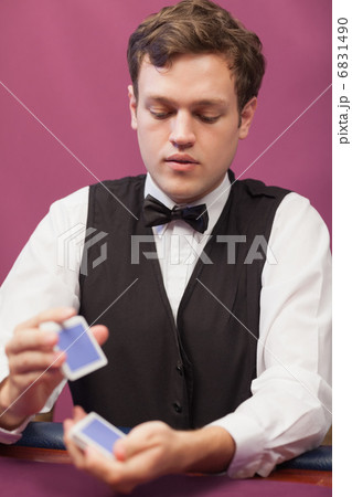 Dealer in a casino shuffling cards 6831490