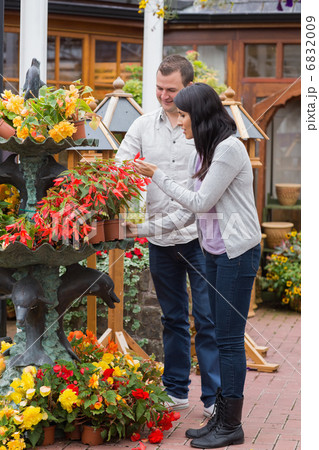 Couple looking at red plant Couple looking at red plant 6832009