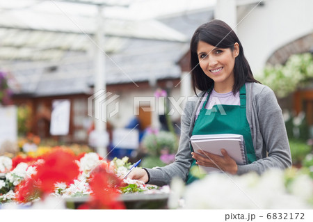 Employee taking notes in garden centre 6832172
