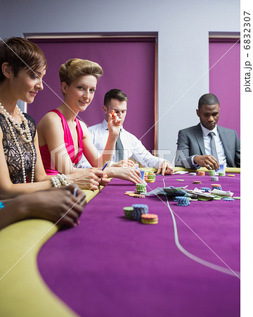 Woman smiling and looking up from poker game 6832307