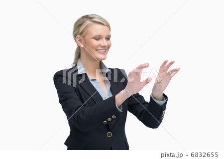 Smiling businesswoman air typing 6832655