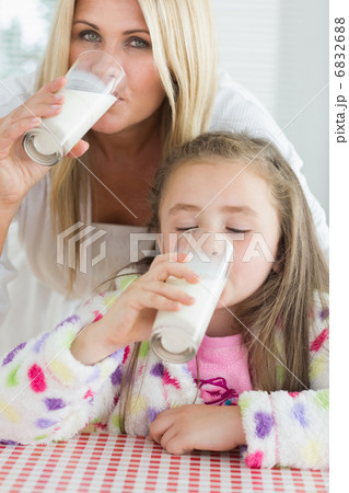 Mother and little girl drinking milk Mother and little girl drinking milk 6832688