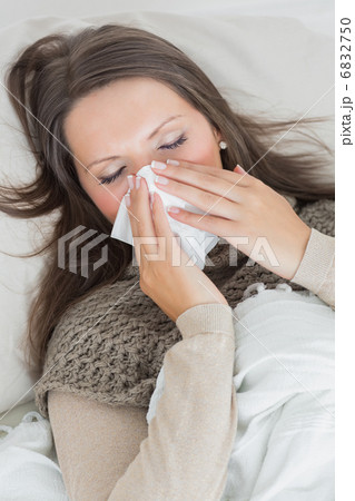 Woman lying on sofa and blowing nose Woman lying on sofa and blowing nose 6832750