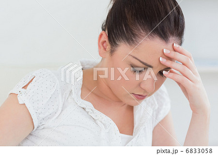 Exhausted woman with her hand on her head 6833058