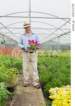 Smiling man holding a flower 6833240