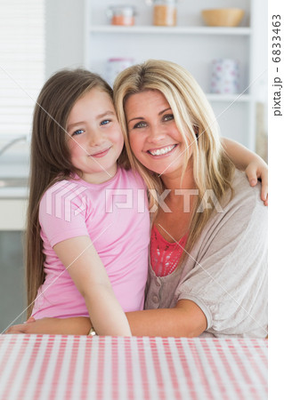 Girl sitting on mothers lap 6833463