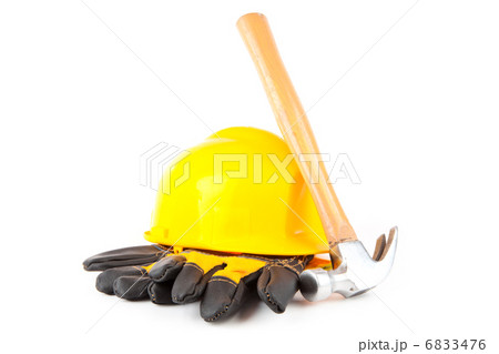 Claw hammer leaning against hard hat and builders gloves Claw hammer leaning against hard hat and builders gloves 6833476