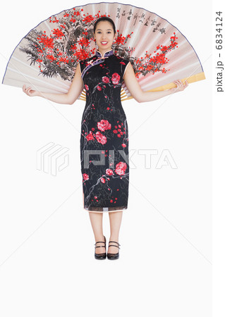 Smiling woman wearing kimono with a fan 6834124