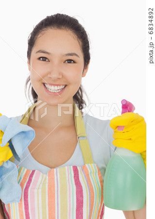 Happy woman holding spray bottle and rag Happy woman holding spray bottle and rag 6834892