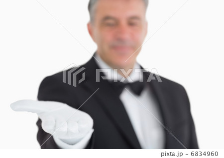 Waiter showing his opened hand 6834960