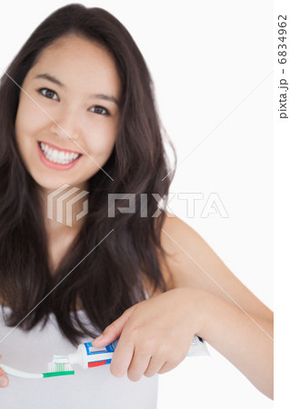 Woman smiling while holding a toothbrush Woman smiling while holding a toothbrush 6834962