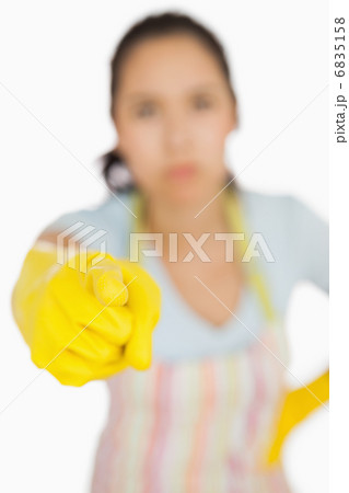 Woman in apron pointing accusingly 6835158