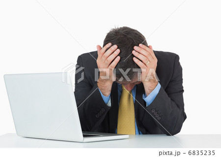 Frustrated businessman with laptop 6835235