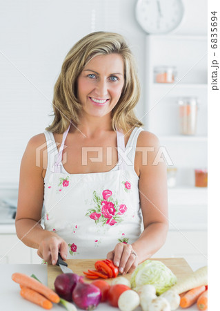 Smiling woman preparing vegetables Smiling woman preparing vegetables 6835694